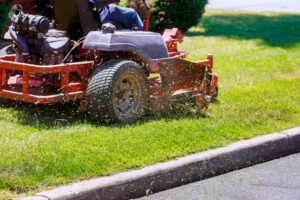 Image of a riding lawn mower cutting some grass